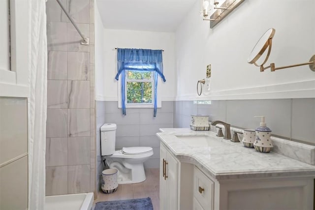 bathroom featuring vanity, toilet, tile walls, curtained shower, and wood-type flooring