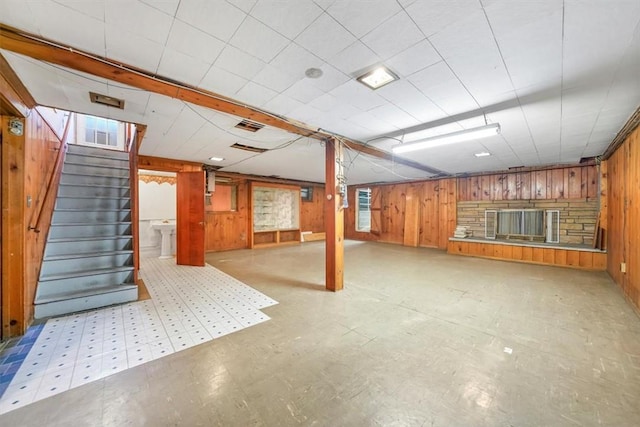 basement featuring wood walls