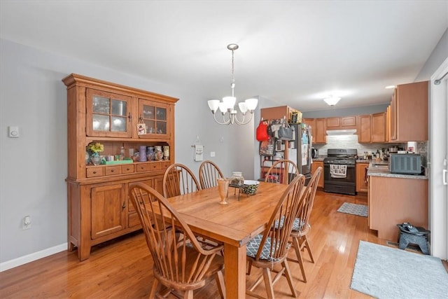 dining area featuring an inviting chandelier and light wood-type flooring