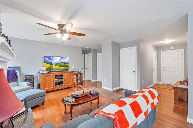 living room featuring ceiling fan and light wood-type flooring