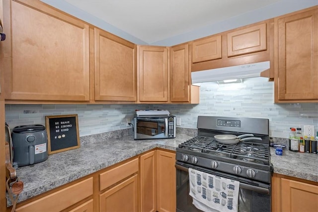 kitchen with black gas range, light brown cabinetry, and decorative backsplash