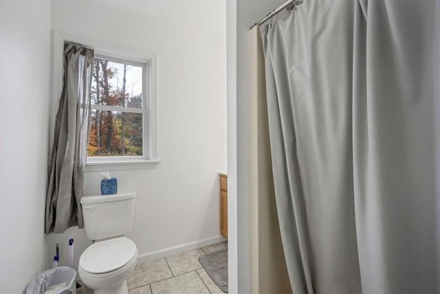 bathroom with tile patterned flooring, vanity, and toilet