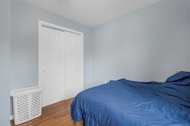 bedroom featuring a closet and dark hardwood / wood-style floors