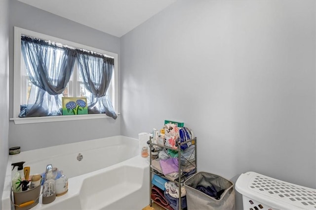 bathroom featuring toilet and a bath