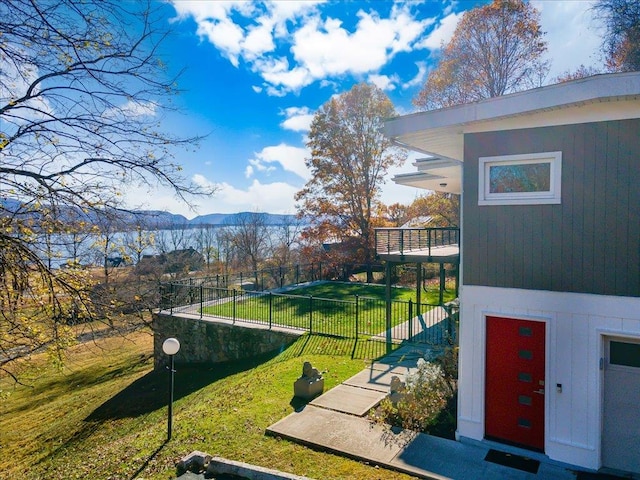 view of community with a mountain view and a yard