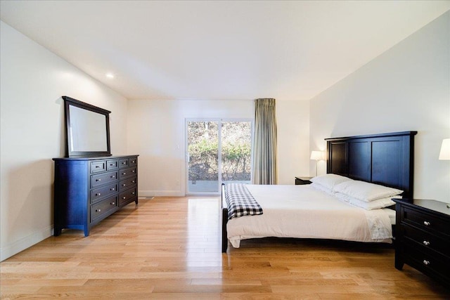 bedroom featuring light hardwood / wood-style floors and access to exterior