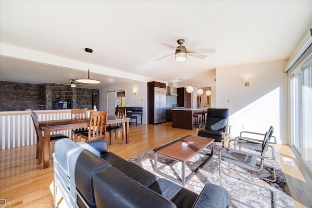 living room with ceiling fan and light hardwood / wood-style floors