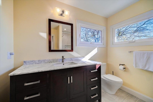 bathroom with tile patterned floors, vanity, and toilet