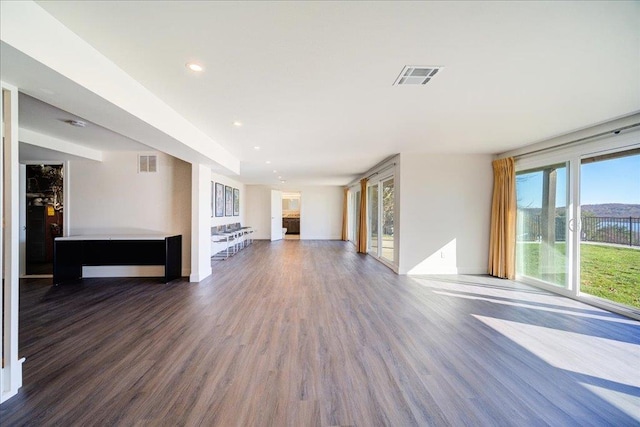 unfurnished living room featuring dark hardwood / wood-style floors