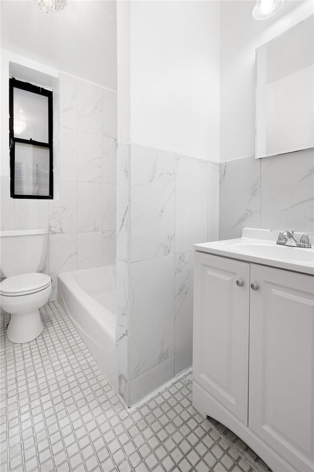 full bathroom featuring vanity, shower / bath combination, tile walls, and toilet