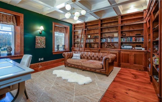 office featuring beam ceiling, coffered ceiling, built in features, a notable chandelier, and hardwood / wood-style flooring