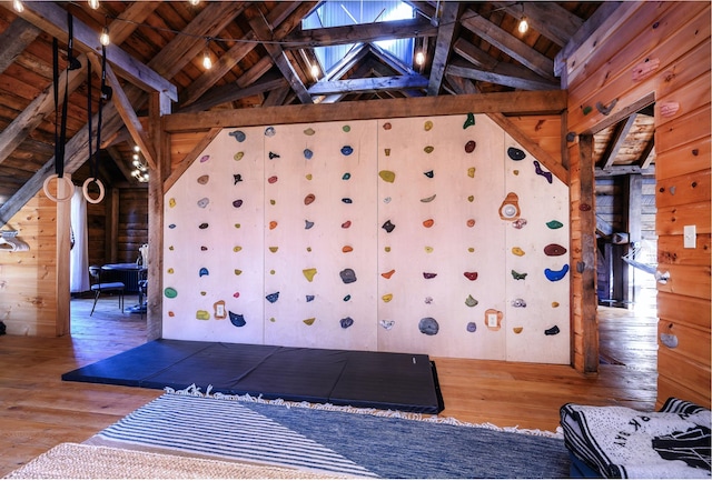 interior space with hardwood / wood-style floors, wood walls, wooden ceiling, and high vaulted ceiling