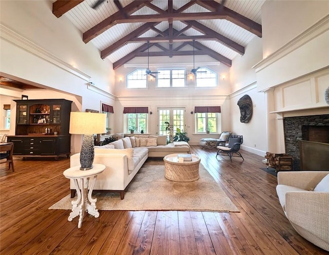 living room with beamed ceiling, dark hardwood / wood-style floors, high vaulted ceiling, and ceiling fan