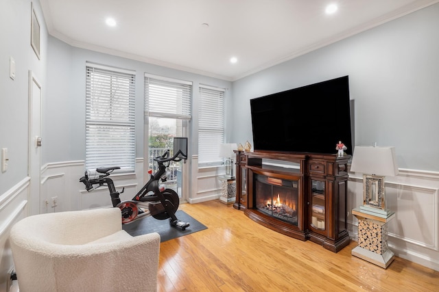 interior space with hardwood / wood-style floors and crown molding