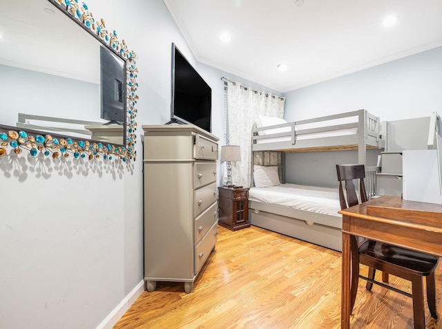 bedroom with ornamental molding and light wood-type flooring