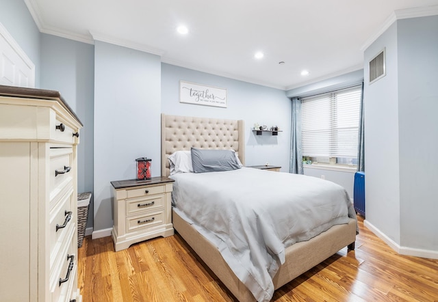 bedroom featuring crown molding and light hardwood / wood-style floors