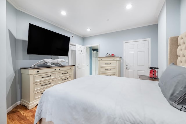 bedroom featuring crown molding and light hardwood / wood-style floors