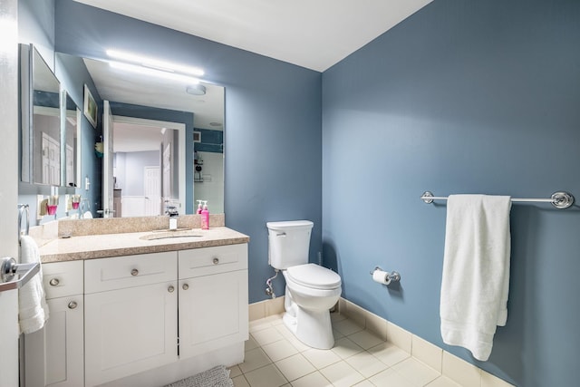 bathroom with vanity, tile patterned floors, and toilet