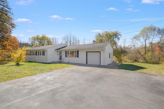 single story home featuring a front yard and a garage