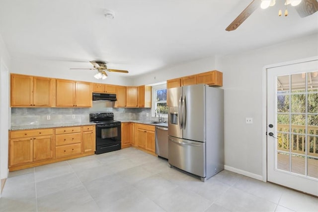 kitchen featuring decorative backsplash, sink, light tile patterned floors, and appliances with stainless steel finishes