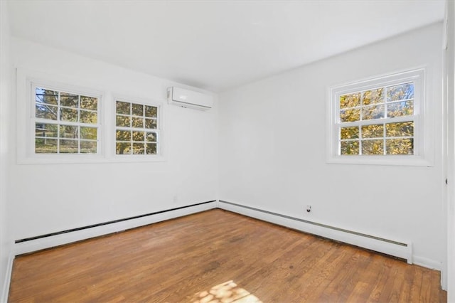 unfurnished room featuring a baseboard heating unit, wood-type flooring, and a wall mounted AC