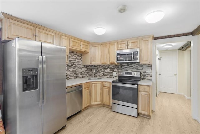 kitchen with sink, light brown cabinets, stainless steel appliances, light hardwood / wood-style flooring, and backsplash