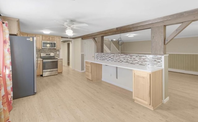 kitchen with decorative backsplash, appliances with stainless steel finishes, light wood-type flooring, light brown cabinetry, and ceiling fan