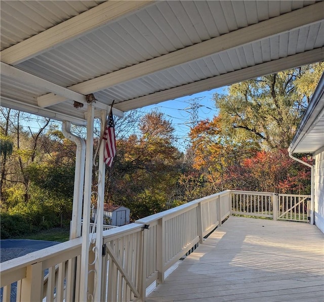 wooden terrace with a shed