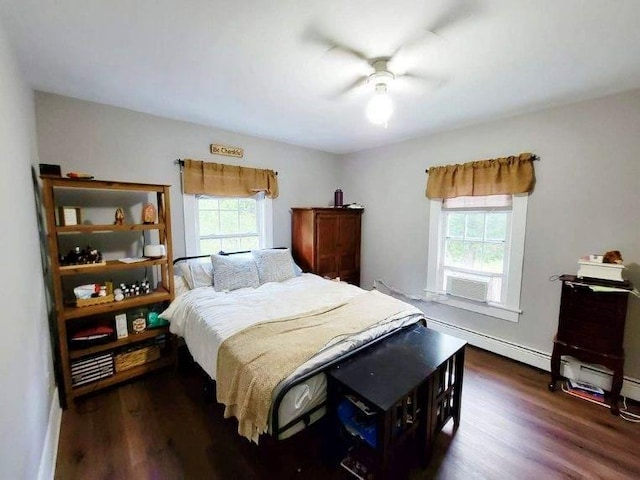 bedroom with multiple windows, ceiling fan, dark hardwood / wood-style flooring, and a baseboard radiator