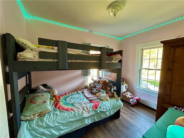 bedroom featuring wood-type flooring and a baseboard radiator