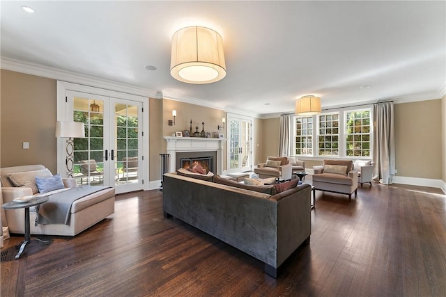 living room featuring ornamental molding, dark wood-type flooring, a wealth of natural light, and french doors