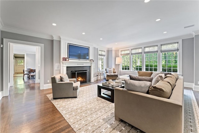 living room with hardwood / wood-style flooring and crown molding