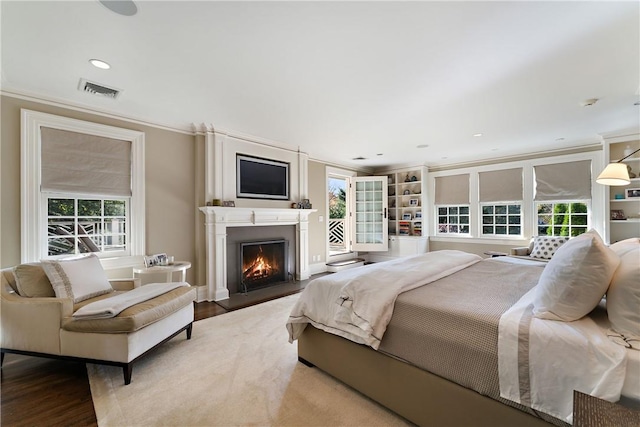 bedroom with hardwood / wood-style floors and crown molding