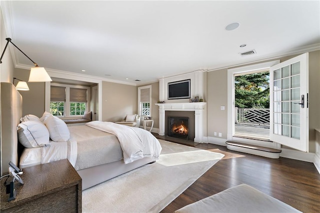 bedroom featuring access to exterior, hardwood / wood-style floors, and ornamental molding