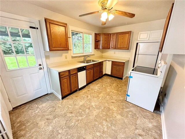 kitchen with white appliances, ceiling fan, and sink