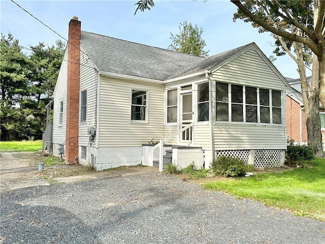 view of front facade with a sunroom