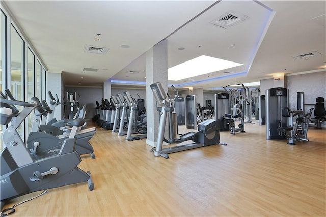 exercise room with light hardwood / wood-style flooring