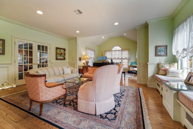 living room with french doors, decorative columns, visible vents, and crown molding