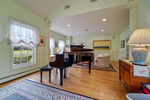 living area with decorative columns, crown molding, visible vents, a baseboard heating unit, and wood finished floors