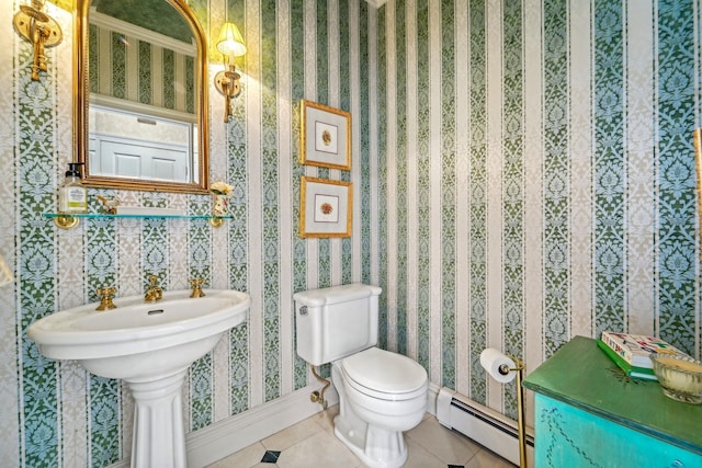 half bathroom featuring toilet, wallpapered walls, baseboard heating, and tile patterned floors