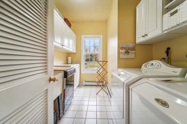 washroom featuring a baseboard heating unit, light tile patterned flooring, independent washer and dryer, and cabinet space