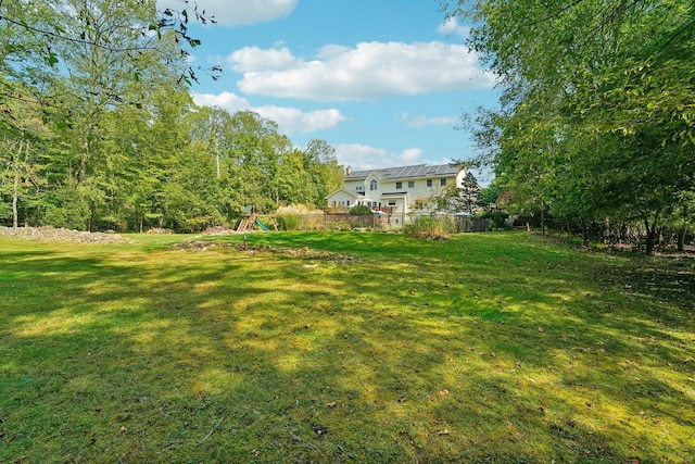 view of yard with a playground and fence