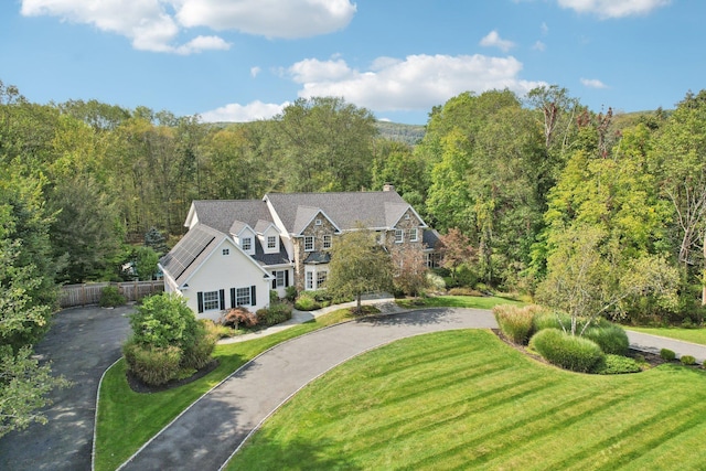 birds eye view of property featuring a view of trees