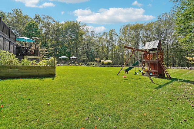 view of yard featuring a playground and fence