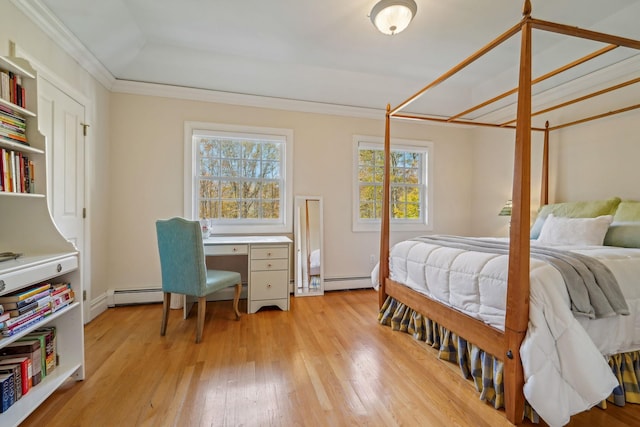 bedroom with a baseboard heating unit, crown molding, and light wood finished floors