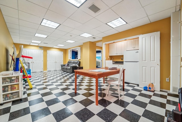 interior space featuring dark floors, visible vents, and a paneled ceiling