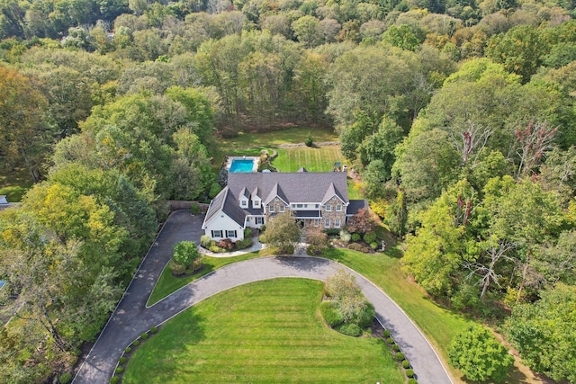 birds eye view of property featuring a view of trees