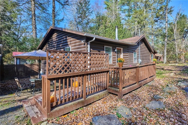 rear view of property featuring a deck