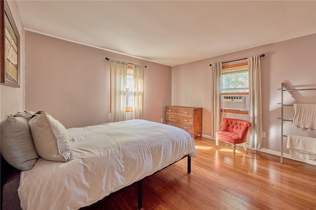 bedroom featuring hardwood / wood-style flooring and cooling unit