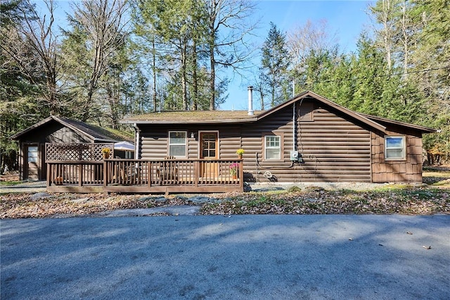 log home featuring a wooden deck